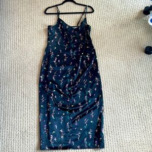 Medium black slip dress with floral pattern.